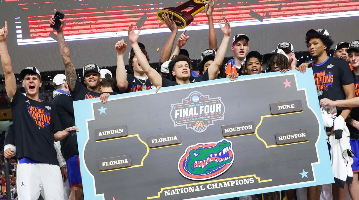 student-athletes holding trophy